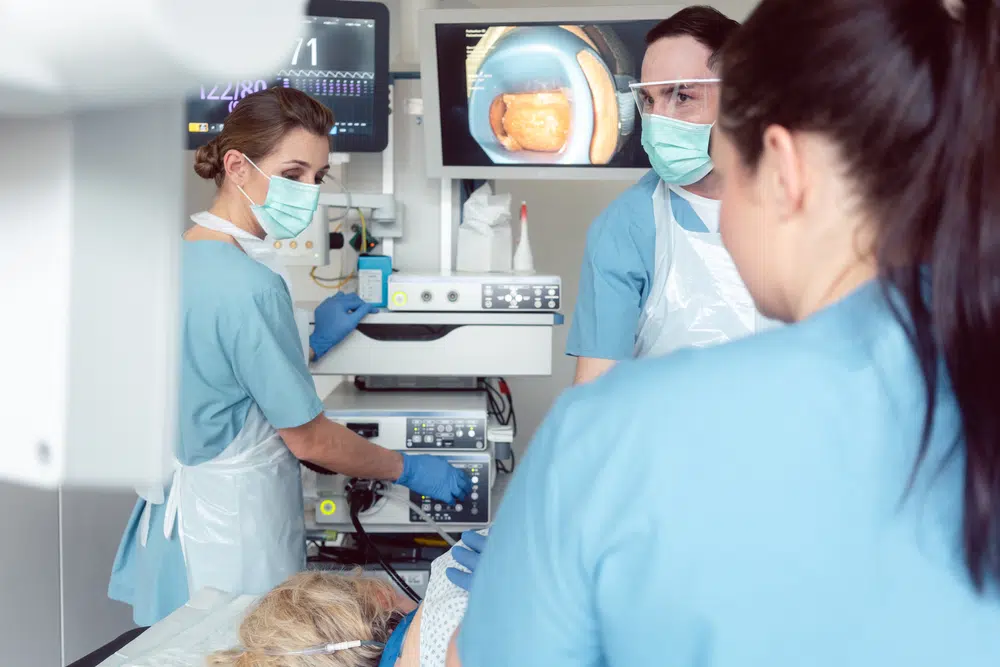 Team of doctors in hospital at endoscopy examining pictures during gastroscopy